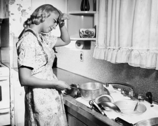 Side profile of a young woman washing utensils in the kitchen Poster ...