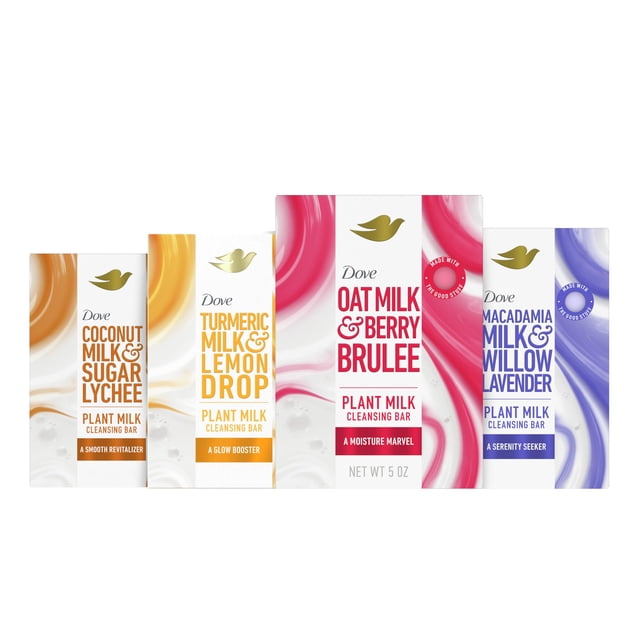 jabón limpiador en barra dove plant milk, paquete variado de 4 x 150 ml — cuatro cajas frontales alineadas, empaque multicolor con remolinos; etiquetas muestran Dove, paloma dorada y las variantes Turmeric Milk & Lemon Drop, Oat Milk & Berry Brulee, Coconut Milk & Sugar Lychee y Macadamia Milk & Willow Lavender, 150 ml por barra; destaca limpieza suave e hidratante.