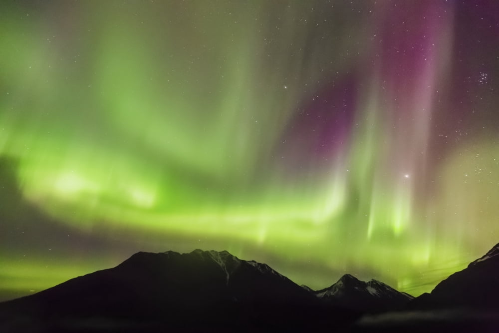 Northern Lights in the sky above Moose Pass silhouetted Kenai Mountains in the foreground fog and low clouds Fall Chugach National Forest Southcentral Alaska USA Canvas Art - Kevin Smith Design Pics