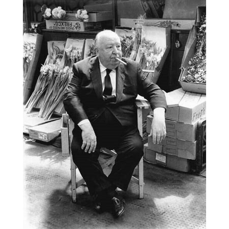 Alfred Hitchcock sits in studio chair on market set of 1972 Frenzy poster