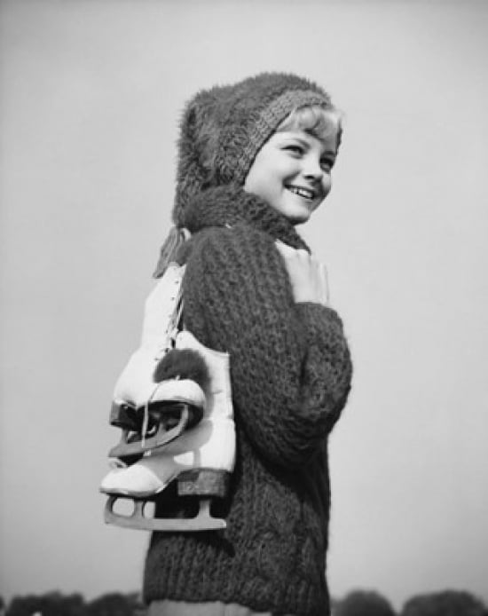 Teenage girl carrying ski boots and smiling Poster Print by Superstock