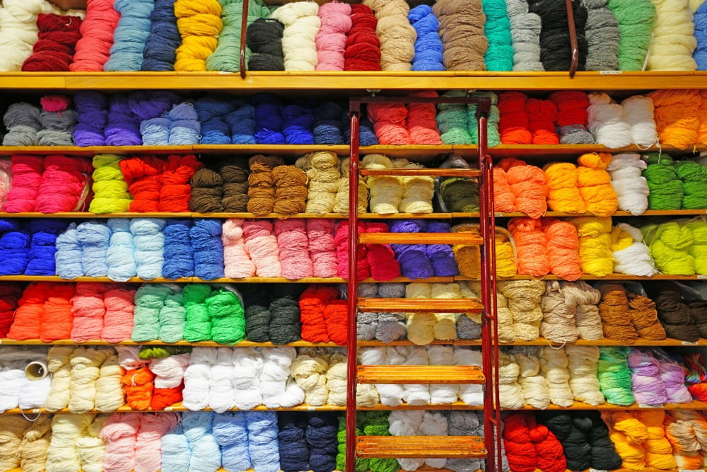 Shelves Filled with Colorful Rolls of Yarn in a Knitting Store