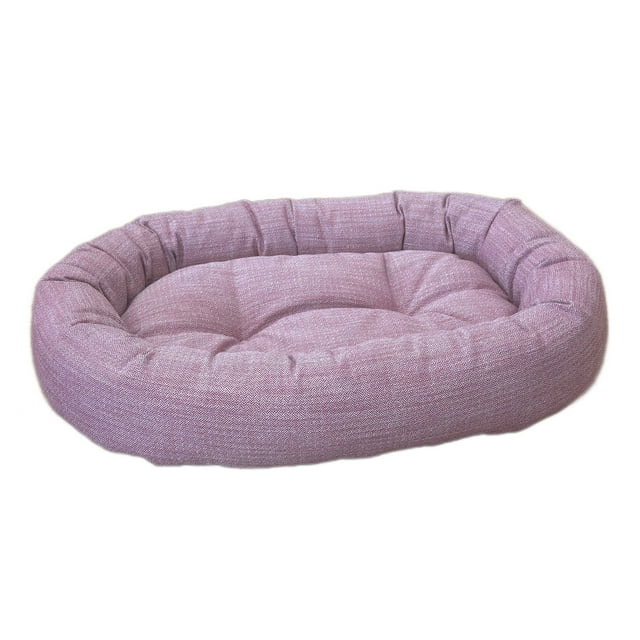 DecoraPet Small Dream Donut Bed in cranberry with oval bolster design and tufted center cushion, made from durable upholstery-grade fabric with a removable, machine-washable zippered cover and filled with high-memory polyester fiber for lasting pet comfort, also suitable as a cozy resting spot for small pets.
