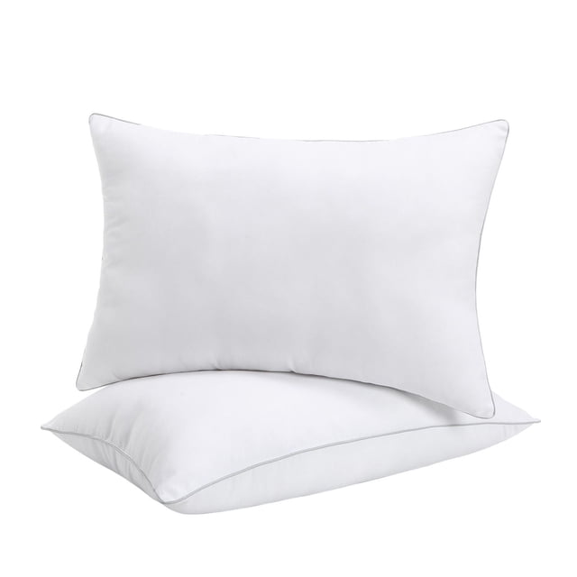 Two breathable medium firm white bed pillows with silver piping from the Marina Decoration Hotel Collection, suitable for side and back sleepers.