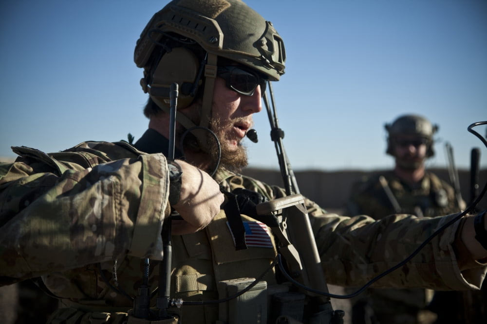 A coalition force member sets up communication with a UH-60 Black Hawk Canvas Art - Stocktrek Images (35 x 23)