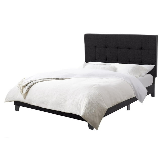 Full size black fabric upholstered bed frame with tufted headboard, slats, and white bedding without box spring.
