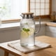 thumbnail image 1 of CaiYueKe Plastic Pitcher with Lid and Strainer, 1L Beverage Jug for Iced Water, Fruit Tea, Bar and Restaurant Use, High-Temperature-Proof PC Water Pitcher for Kitchen, Dining, KTV, Clear Juice Jug, 1 of 7