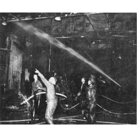 LAMINATED POSTER Crewmen fighting fires in the hangar bay of the U.S. aircraft carrier USS Intrepic (CV-11) after a Poster Print 24 x