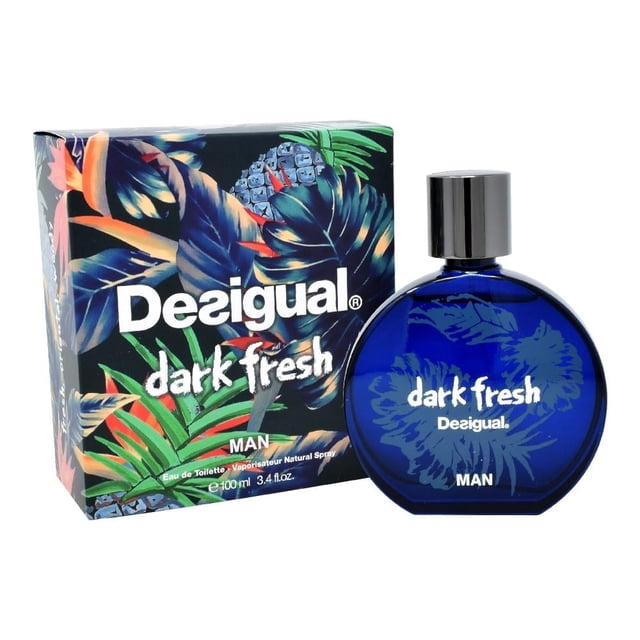 Fragancia Desigual Fresh Dark 100 ml para hombre con botella redonda azul oscuro y tapa plateada, acompañada de caja con diseño tropical en tonos azules y verdes, ideal para uso diario y ocasiones especiales.