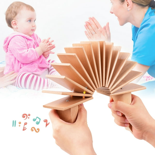 labymos castañuela de madera clacker clapper sonajero Vista frontal de un badajo de madera de haya con lamas apiladas en forma de abanico sostenidas por dos mangos; superficie lisa y pequeñas clavijas visibles. Juguete musical para bebés y niños, ideal para entrenar el sentido del ritmo y la motricidad fina; también se suele usar como sonajero en actividades de estimulación temprana.