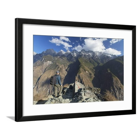 Man hiking in Tiger Leaping Gorge, UNESCO World Heritage Site, with Jade Dragon Snow Mountain (Yulo Framed Print Wall Art By Ian