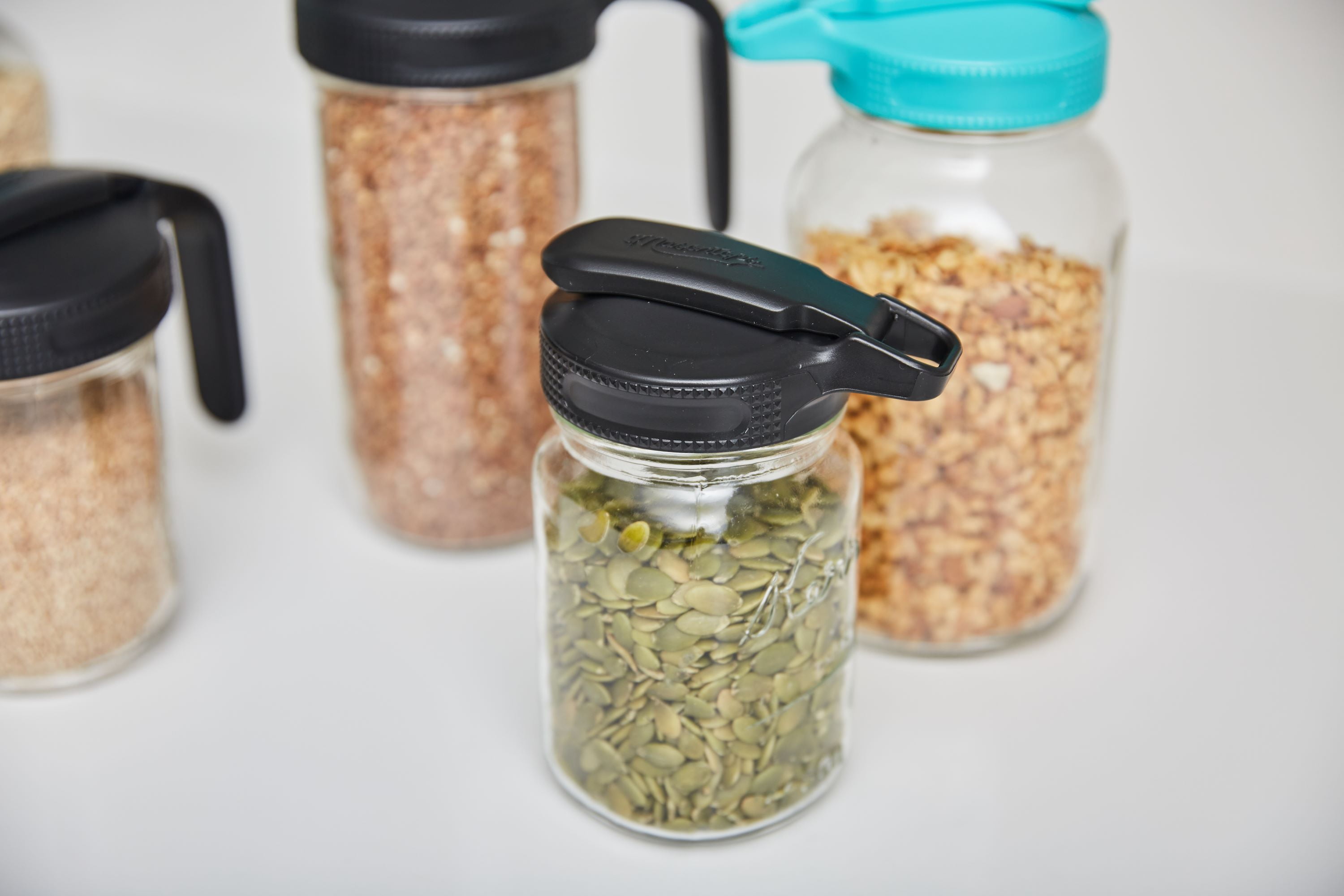 (4 pack) Masontops Regular Mouth Mason Jar Lid with Flip Top Pour Spout, Reusable Plastic Canning Jar Lid for Liquid and Dry Food Storage, BPA-Free and Dishwasher Safe, Black