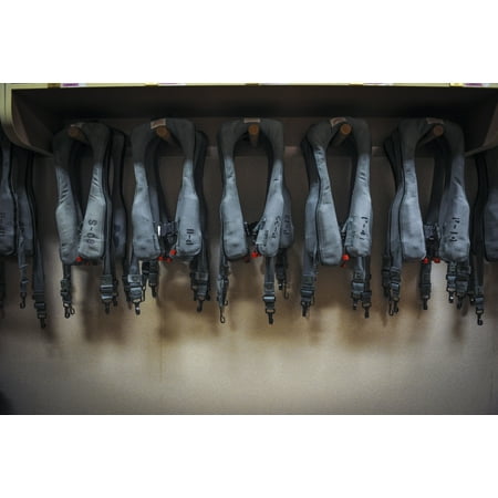 Unit Black Flight Vinyl LAMINATED POSTER Life Preserver Units (LPUs) hang in the Air Crew Flight Equipment shop at Eielson Air Force Base in Poster Print 24 x 36 ()