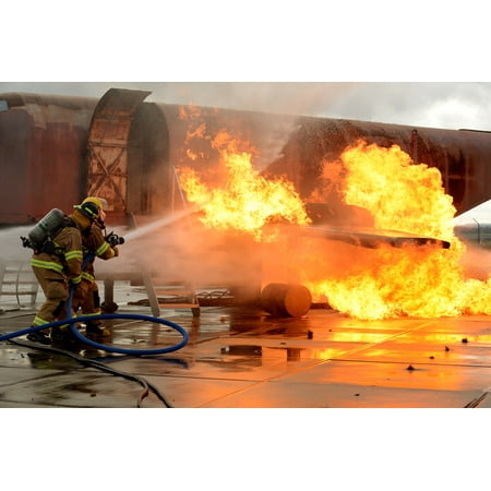 LAMINATED POSTER U.S. Air Force firefighters suppress an engine and fuel fire during a live-fire training exercise Ja Poster Print 24 x