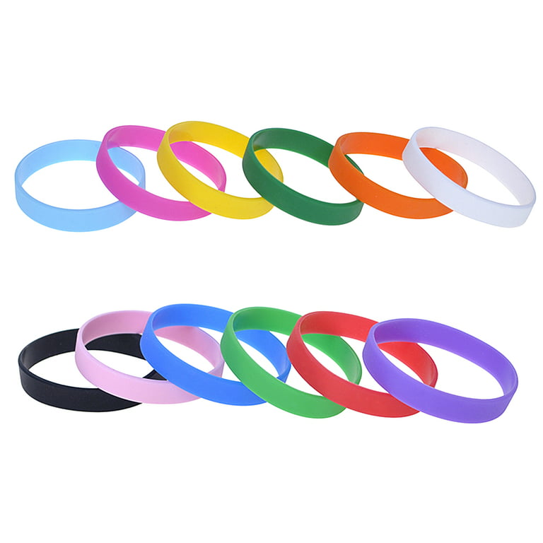 Blank rubber wristbands on wrist arm. Silicone fashion round social  bracelet wear on hand. Unity band. Stock Photo