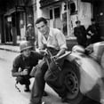 thumbnail image 2 of U.S. Army Lieutenant And French Partisan Crouch Behind An Auto In Street Fighting. Summer 1944. World War 2., 2 of 2