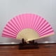 thumbnail image 1 of Abanico de papel plegable de 7 pulgadas 007 Rosa, Abanico de boda de danza de patrón plegable de encaje de seda de color sólido, 1 of 2