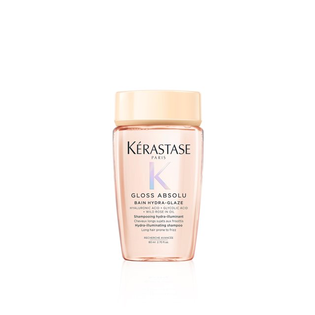 champú kérastase gloss absolu high-shine anti-frizz 75 ml Botella frontal centrada, envase translúcido rosado con tapa beige y logotipo Kérastase; etiqueta 'Gloss Absolu Bain Hydra-Glaze' indica ácido hialurónico y efecto anti-encrespamiento, fondo blanco limpio; apto para cabello brillante y flexible.