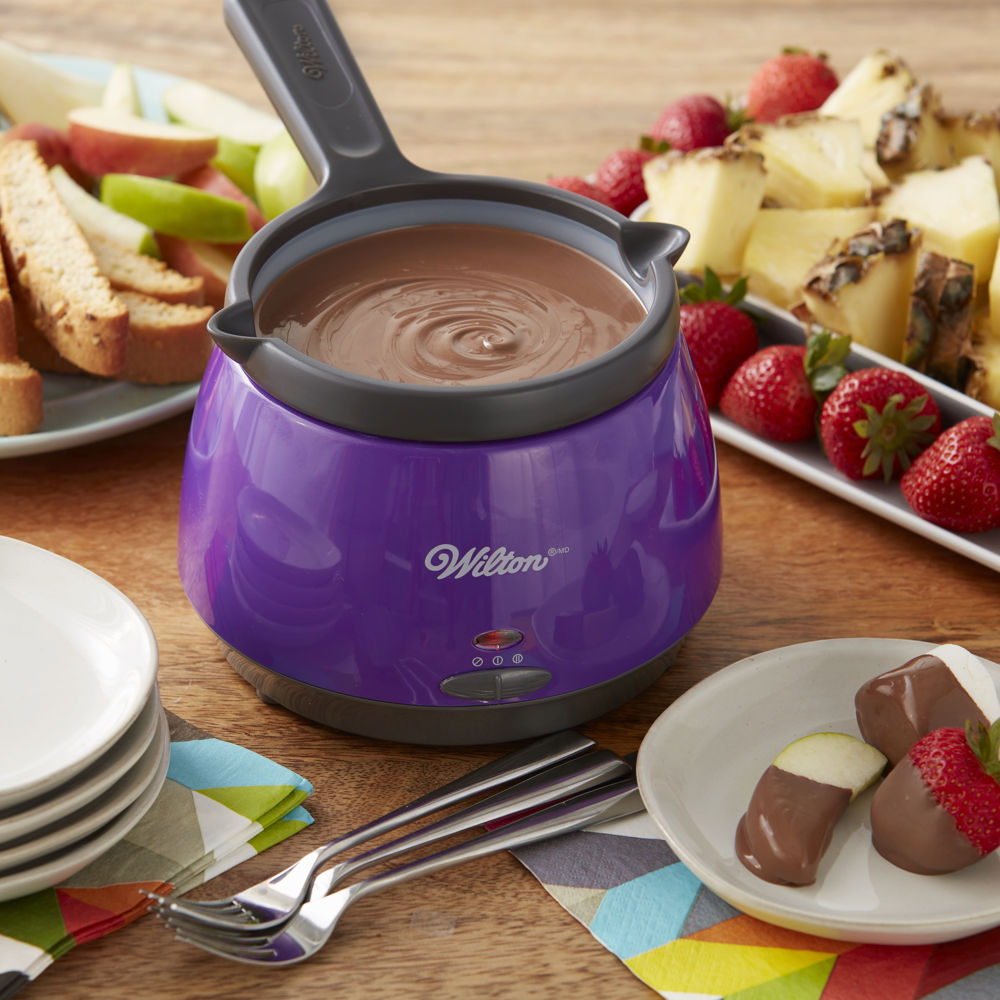 Premium Photo  Melting chocolate melts in a candy melting pot to prepare  gourmet mini chocolates with sprinkles