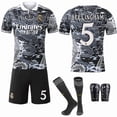 thumbnail image 1 of 2425 Real Madrid Motif dragon Noir et Blanc Édition Commémorative Spéciale Rétro No. 9 Mbappe 7 Vinicius 5 Bellingham No. 5 avec Chaussettes + Équipement de Protection Ensemble de Maillot de football Classique, 1 of 2