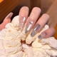 thumbnail image 4 of Uñas postizas largas con diseño francés de lunares, lazo y pedrería, hechas a mano, 4 of 38