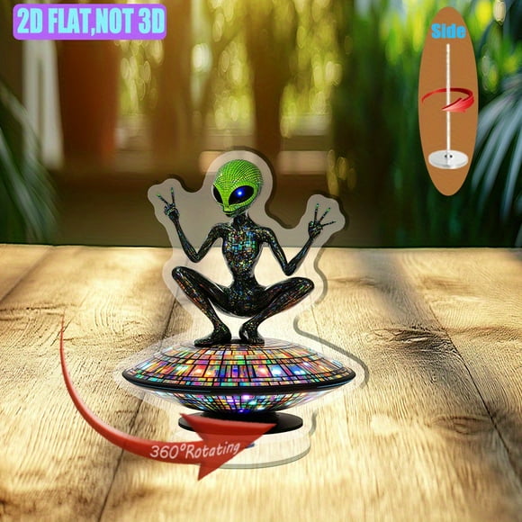 Rotatable acrylic display features an alien with a green head and glowing black eyes on a mosaic UFO adorned with colorful LED lights