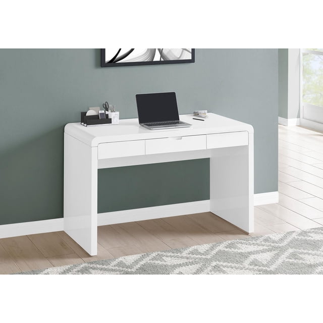 Glossy white laminate Monarch Specialties computer desk with three storage drawers holding a laptop and office supplies in a modern home office setting.