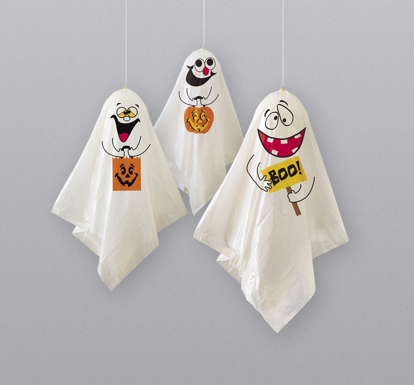 Three hanging ghost decorations, each with a different facial expression