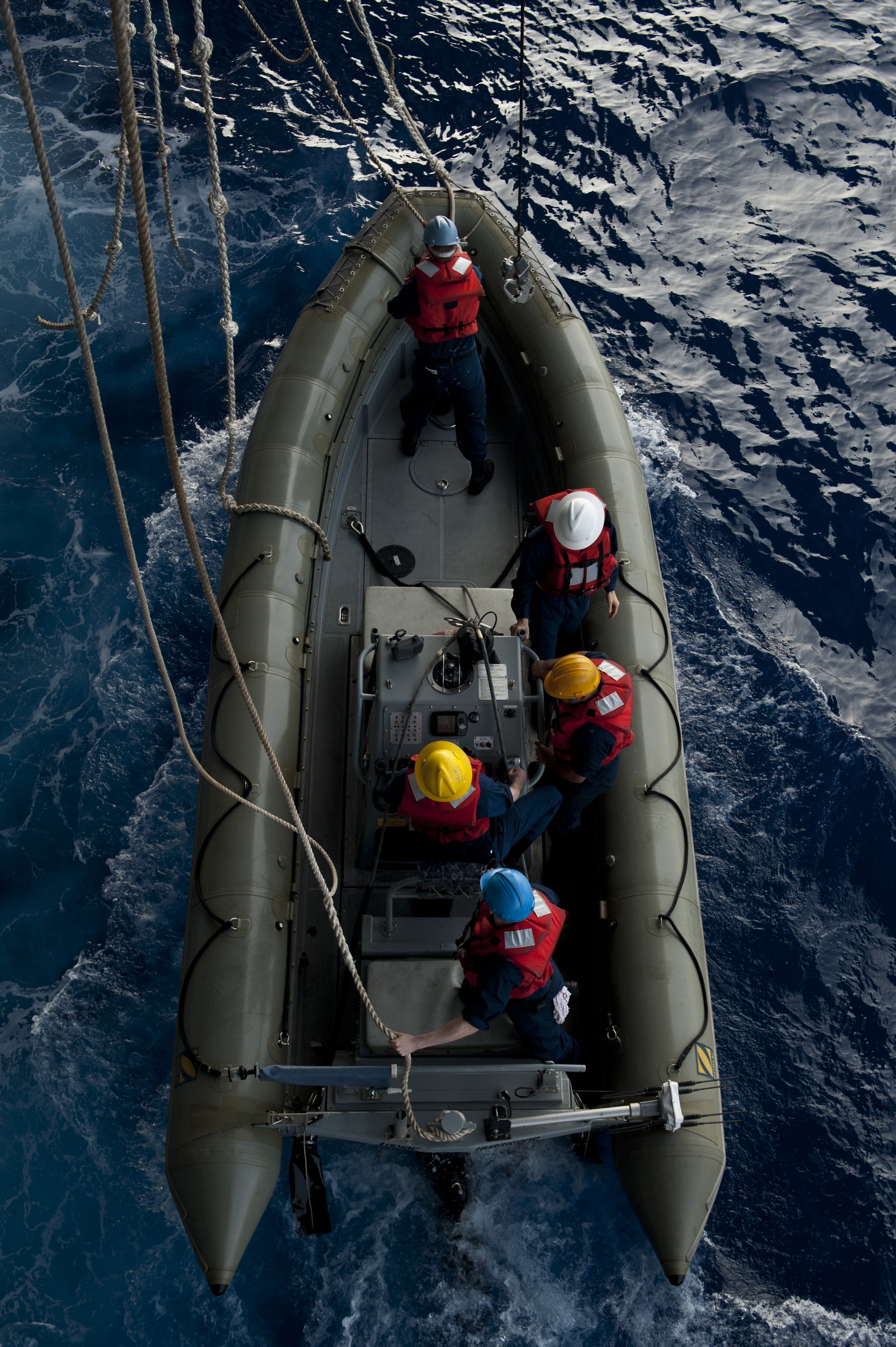 LAMINATED POSTER Sailors are lowered into the water during rigidhull inflatable boat (RHIB