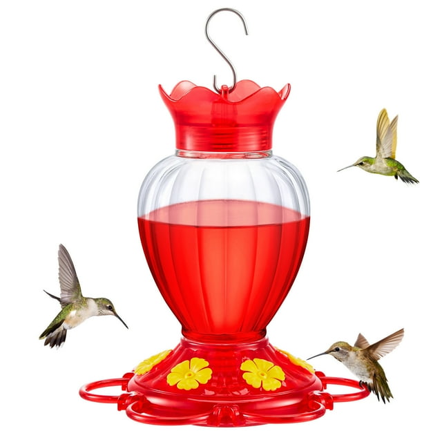 comederos para colibríes los comederos colgantes para pájaros en el patio al aire libre están decorados para la observación de aves comedero para colibríes Vista frontal colgante; depósito transparente con líquido rojo, tapa roja con borde ondulado, base roja con cuatro puertos de alimentación amarillos en forma de flor y anilla para colgar; también apto para observación de aves en patios y terrazas.