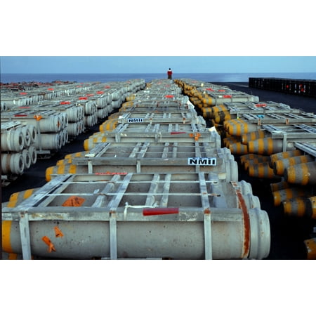 End Boards - LAMINATED POSTER Aviation ordnceman stand at the far end of staged ordnance on board Nimitz-class aircraft carrier U Poster Print 24 x 36