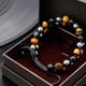 thumbnail image 4 of Pulsera de protección triple YONGSHENG obsidiana negra ojo de tigre genuino cuentas de hematita 8 mm, 4 of 5