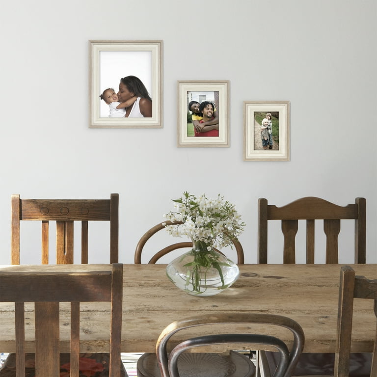 Four Wooden Photo Frames Held Up On A Table Background, Picture