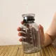 thumbnail image 5 of Botella de agua de vidrio libre de BAP de 350/450/750 ml con pajita Time Maker, 2 tapas, taza para beber leche y jugo transparente kawaii, regalo simple, 5 of 6
