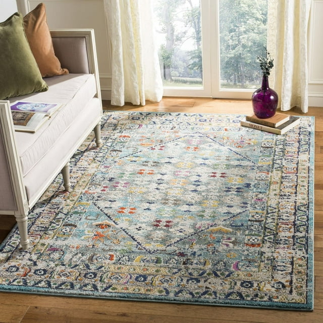 SAFAVIEH Monaco Garnet abstract geometric area rug featuring multicolor floral and diamond motifs on hardwood floor next to sofa and purple vase
