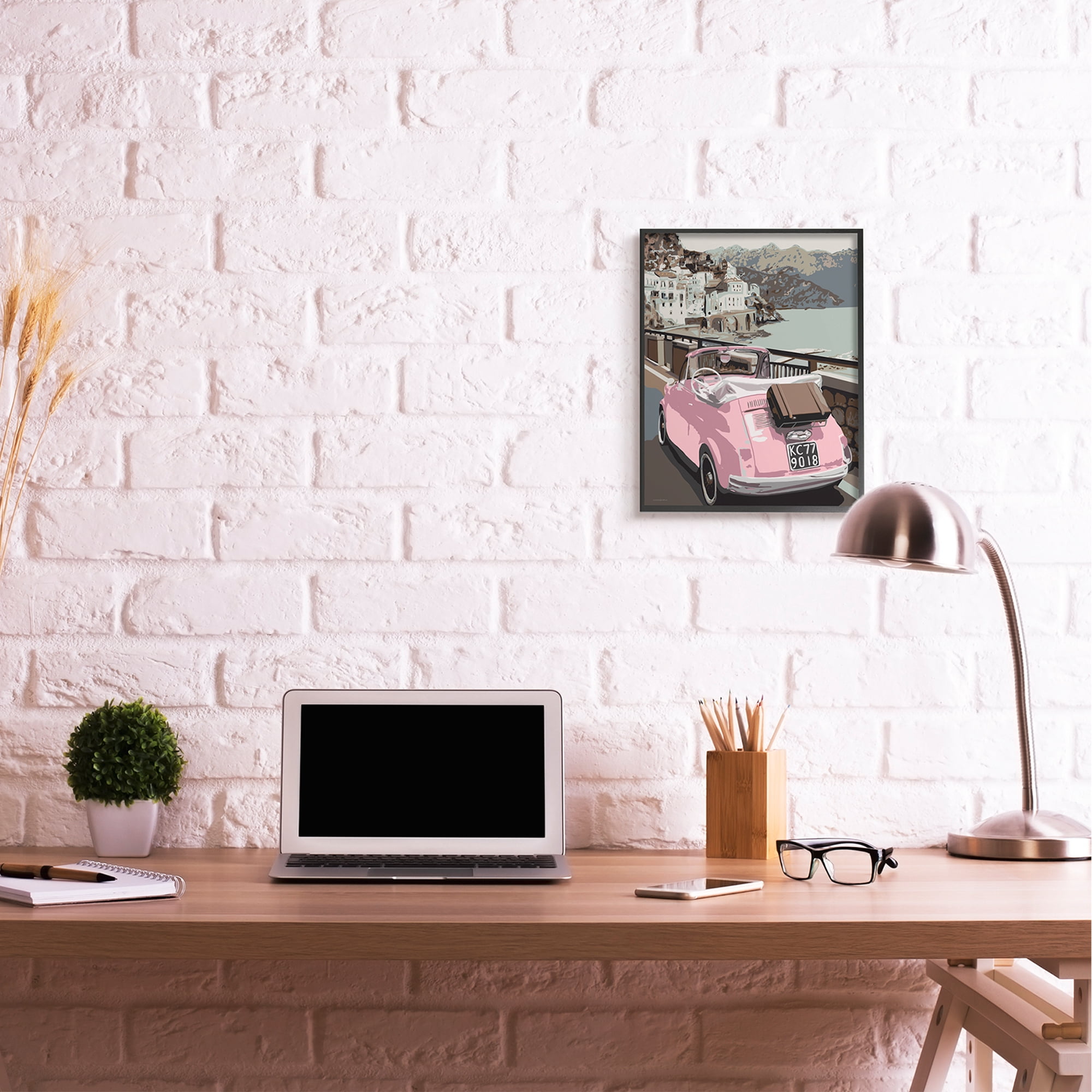 Industries Pink Car Cliffside Town on Waterfront Road 16 in x 20 in Framed Painting Art Print, by Stupell Home Décor