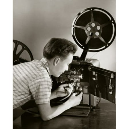 Side profile of a boy loading a film reel on a projector Stretched Canvas -  (24 x