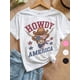 thumbnail image 1 of Camiseta patriótica de algodón para niña del 4 de julio: corte holgado, cómoda, con la bandera de EE. UU. y diseño de vaca con la inscripción "HOWDY AMERICA", manga corta y cuello redondo, para niñas, 1 of 6