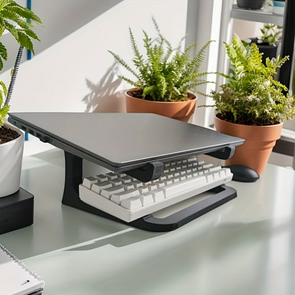 Portable Plastic Laptop Stand Ergonomic design with sturdy construction Features cooling support and desktop riser Compatible with 11-14 inch laptops Ideal for office, home, and travel use