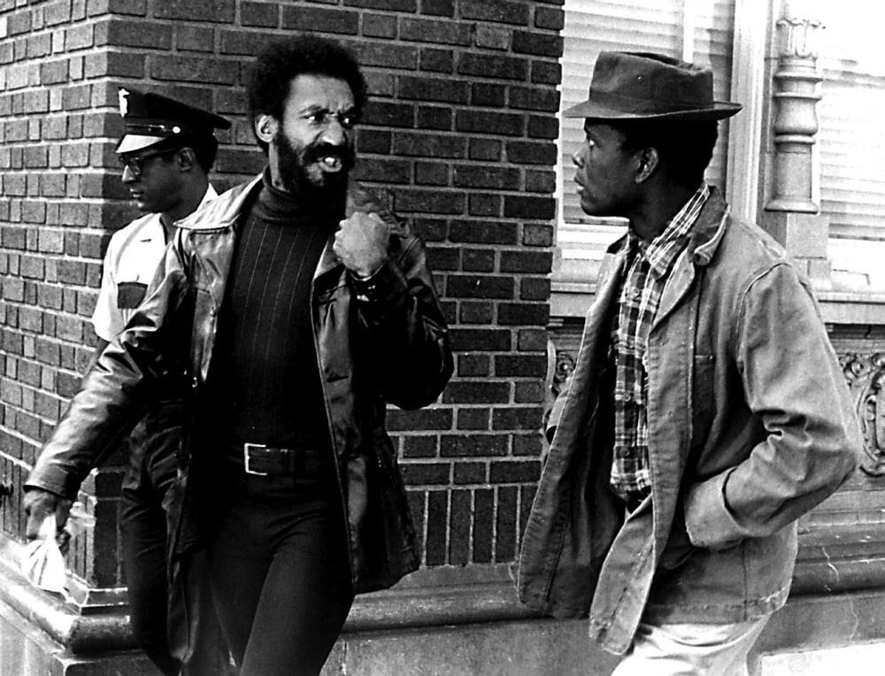 Sidney Poitier and Bill Cosby with fist up Uptown Saturday