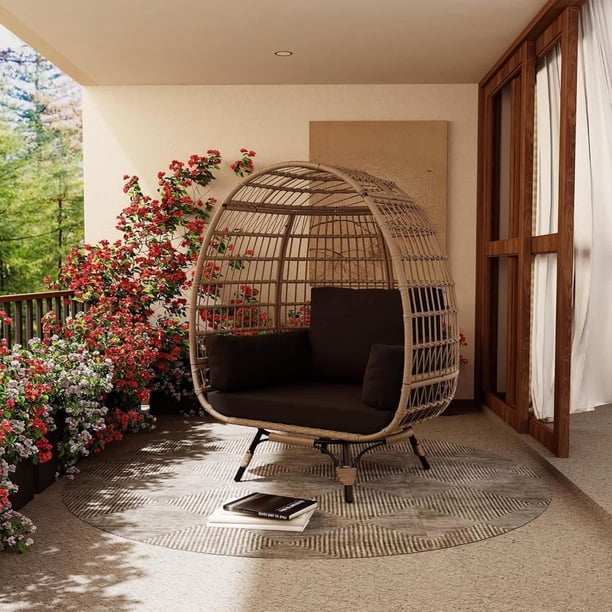 Elegant single-person spinning egg chair: 360-degree rotating design, negra steel frame, brown rattan seat, negra mat - enjoy ultimate comfort & style
