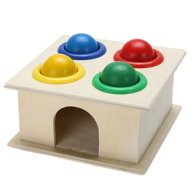 Educational Toys Wooden Hammering Ball with Hammer Box Color Cognitive Toy featuring a natural wood box with four colorful balls (red, blue, green, yellow) partially inserted into matching color-coded holes on the top. Includes a wooden hammer for striking the balls through the holes, promoting hand-eye coordination and color recognition. Suitable for children aged 3 years and older.