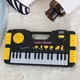 thumbnail image 3 of Teclado Piano Electrónico 31 Teclas | Instrumento musical portátil | Diseño de plástico ligero | Aprendizaje interactivo y creatividad | Ritmos de 2 tonos | Amarillo | 12x6.1x1.37in | Alimentado por, 3 of 6