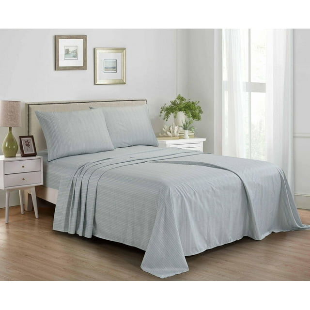 Light grey 4 piece printed microfibre bed sheet set on a neatly made bed in a bright bedroom.
