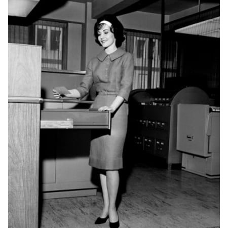Insulated Holding Cabinet - Businesswoman holding a card beside a filing cabinet Stretched Canvas - (24 x 36)