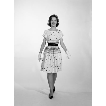 1960s-1950s Smiling Woman Walking To Looking At Camera Wearing Polka Dot Cotton Dress High Heel Shoes And White