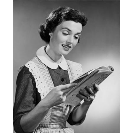 - Young woman reading magazine Poster Print