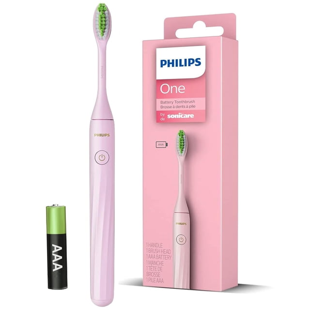 philips one cepillo de dientes eléctrico hy1100/56 (rosa claro) + pila aaa, vista frontal centrada del cepillo eléctrico rosa claro con mango cilíndrico y botón circular, cabeza con cerdas suaves y almohadillas verdes, caja rosada con logo Philips One y pila AAA visible; suele usarse también para limpieza de prótesis dentales removibles por su cabezal compacto.