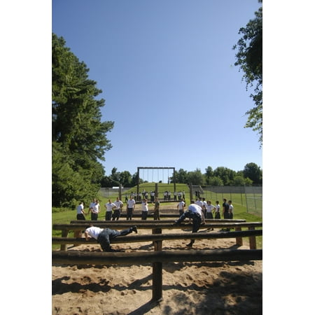 Plebes in the US Naval Academy Class of 2015 run the schools obstacle course Poster