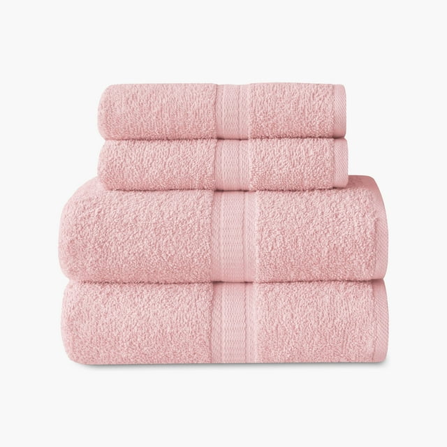 Set of four soft pink Mainstays Basics towels including 2 bath and 2 hand towels neatly stacked.